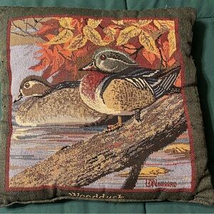 12”x12” duck pillow with green trim and a black back, a few thread pulls